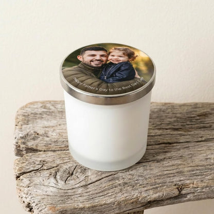 Personalised Fathers Day candle in white frosted glass jar with photo of dad and child printed on the silver-coloured lid, displayed on rustic driftwood.