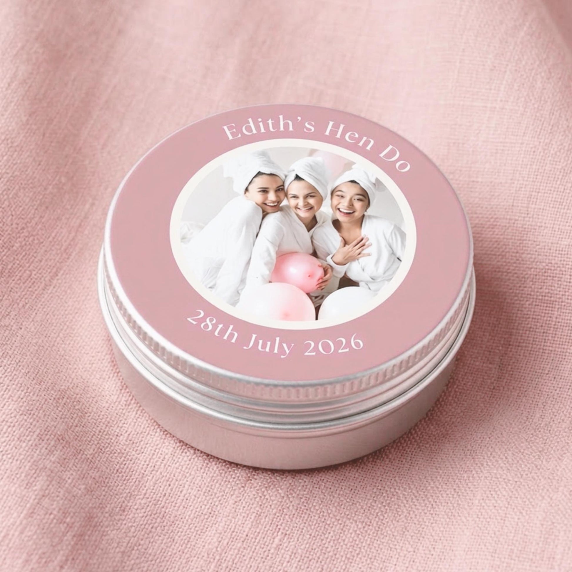 Personalised party favour candle tin with lid removed, showing natural olive wax candle and cotton wick inside — vegan and cruelty-free
