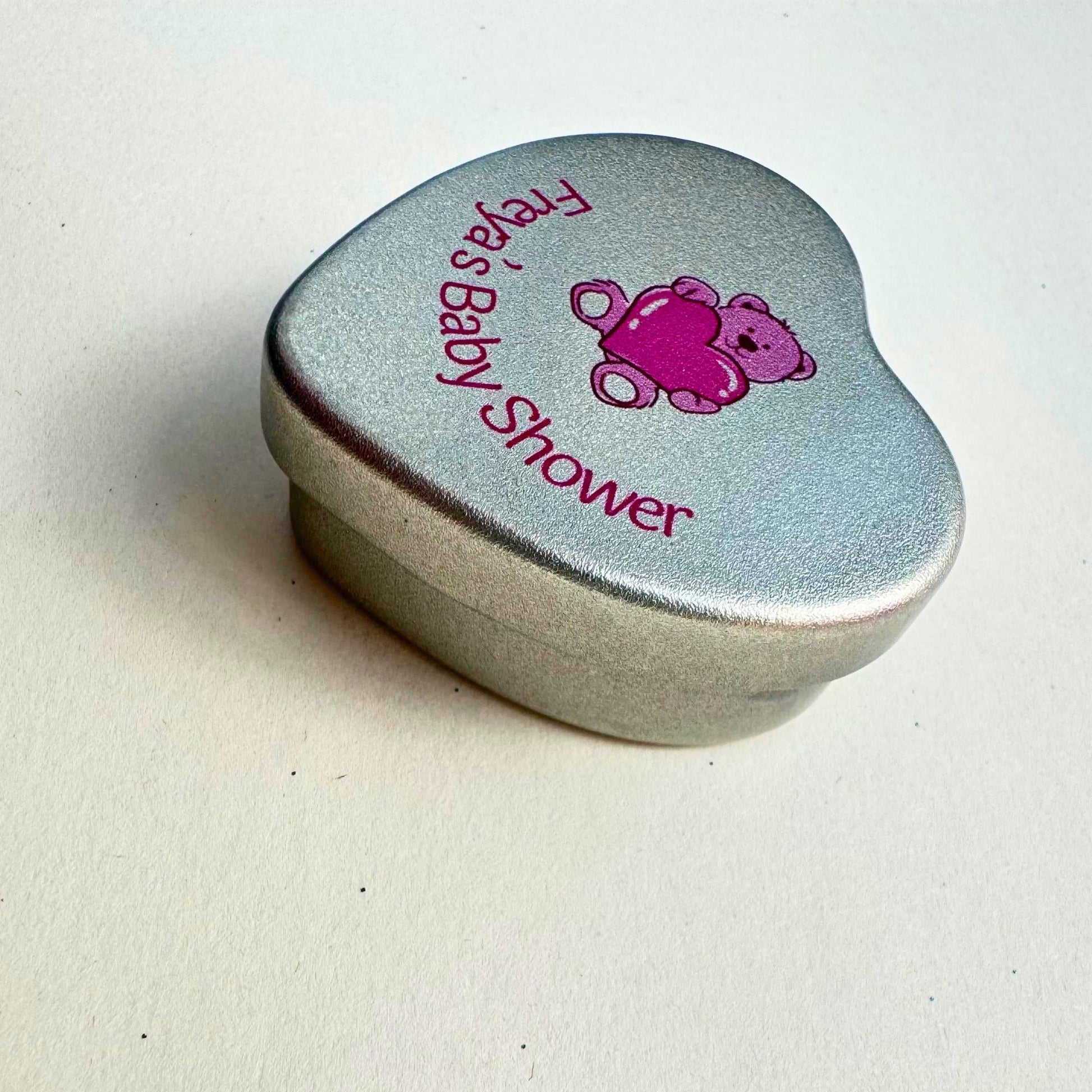 Personalised pink teddy bear baby shower heart tin candle favour — close-up side view of silver tin lid