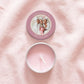 Flat lay of personalised hen party candle tin favour, lid and tin separated showing colour-printed photo design with custom text and date, open tin revealing candle and white cotton wick