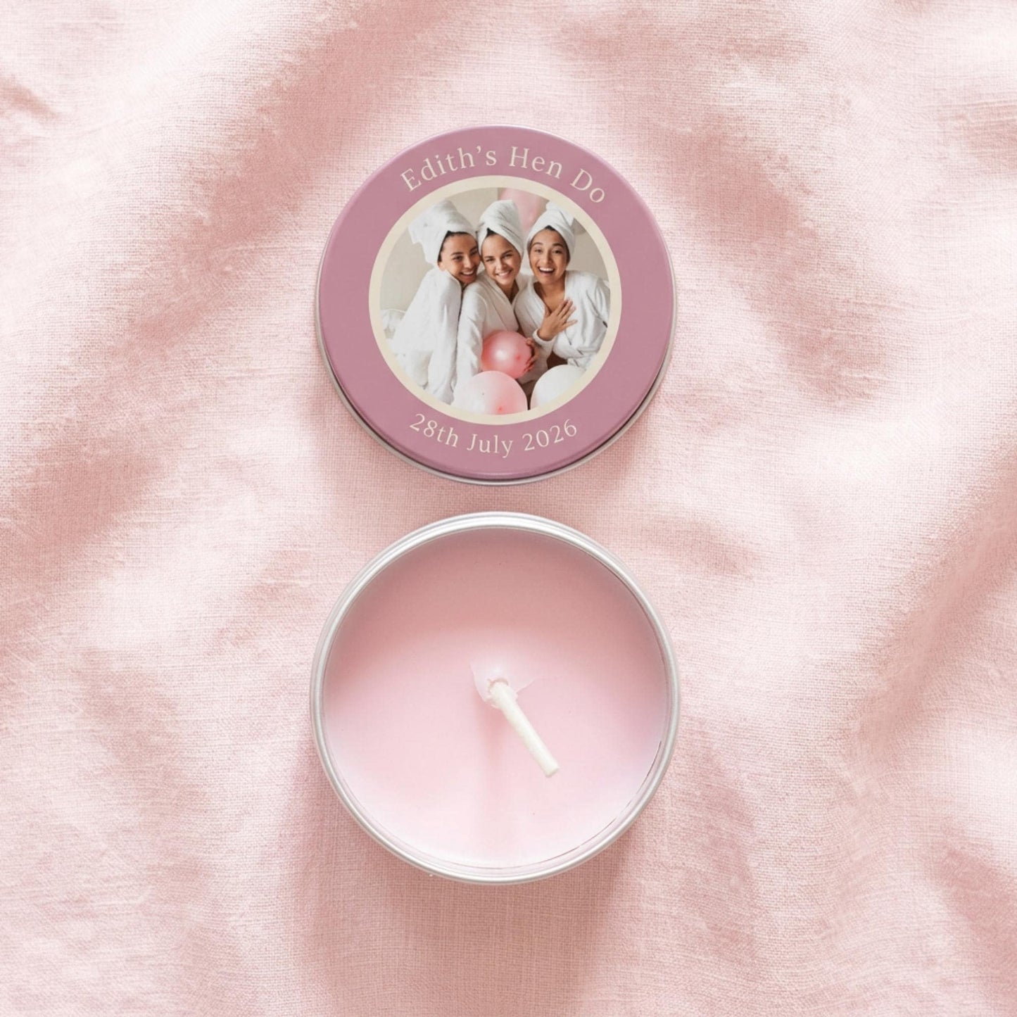 Flat lay of personalised party favour candle tin, lid and tin separated showing colour-printed photo design with custom text, open tin revealing candle and cotton wick