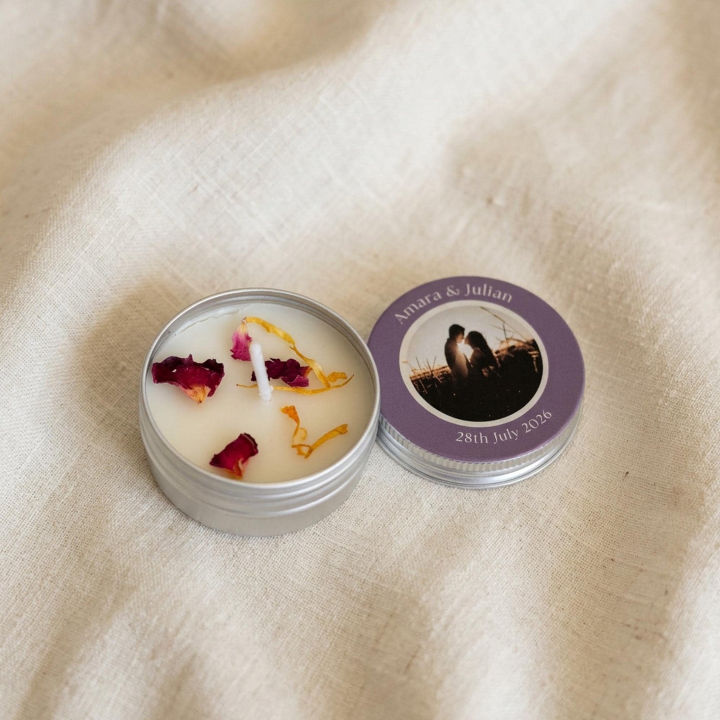 Personalised party favour candle tins arranged as table decorations, showing colour-printed photo lids with bespoke designs
