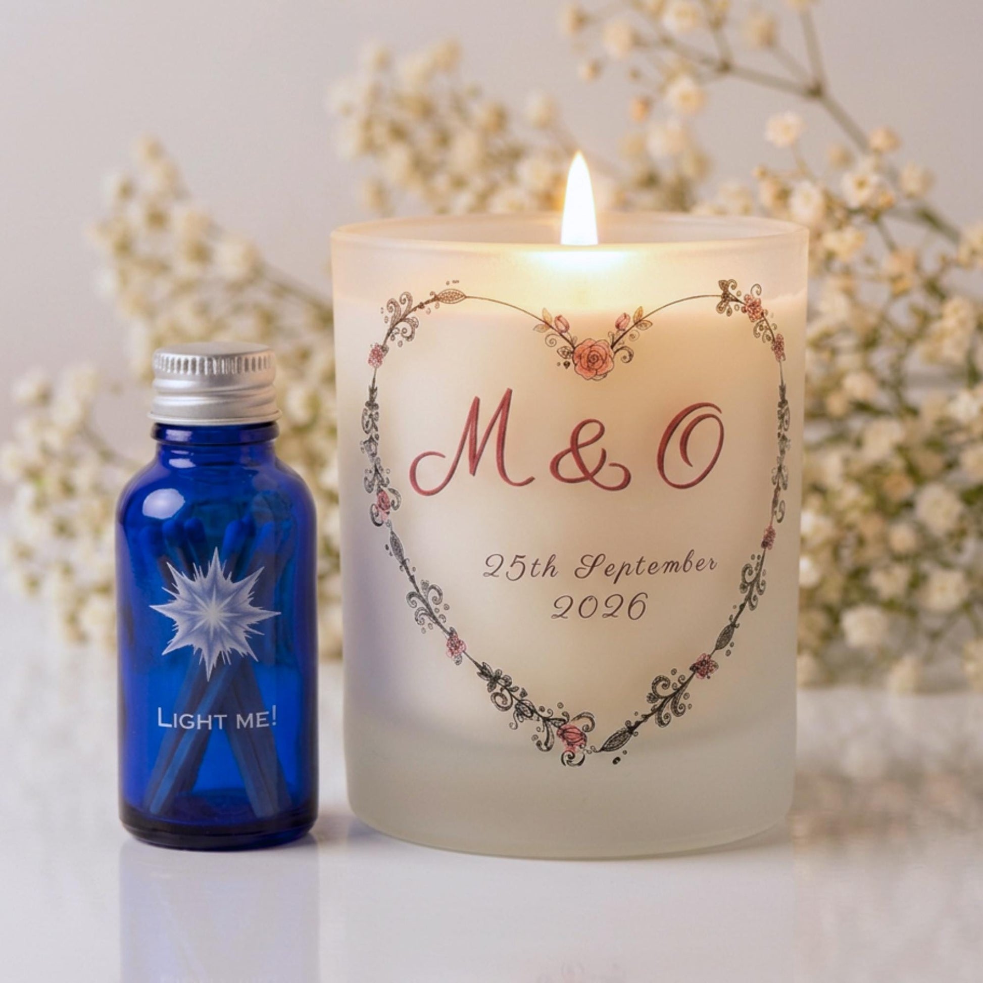 Personalised wedding candle with couple's initials and date in a boho floral heart design