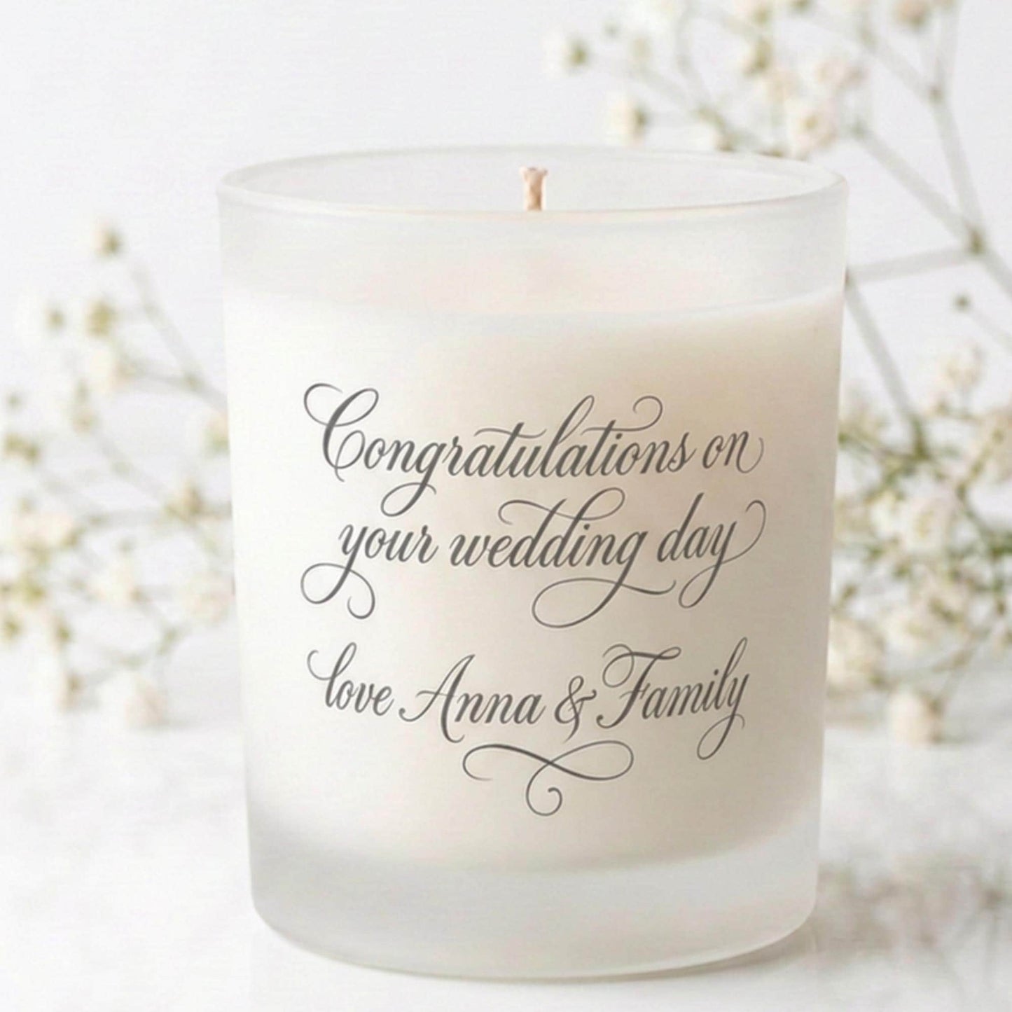 Personalised wedding candle with couple's initials and date in a boho floral heart design