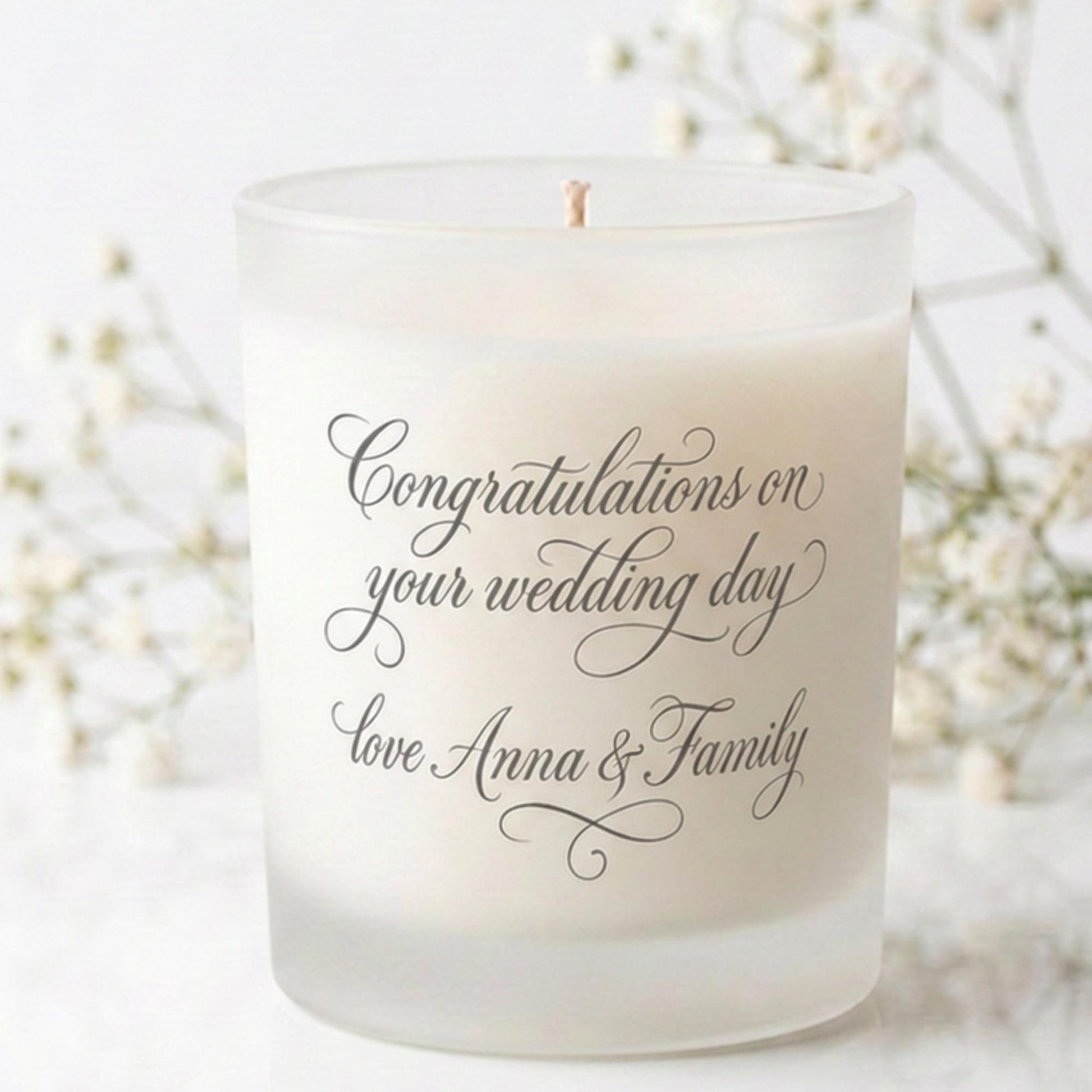 Personalised wedding candle with names and date in a hand-drawn daisy design on frosted glass