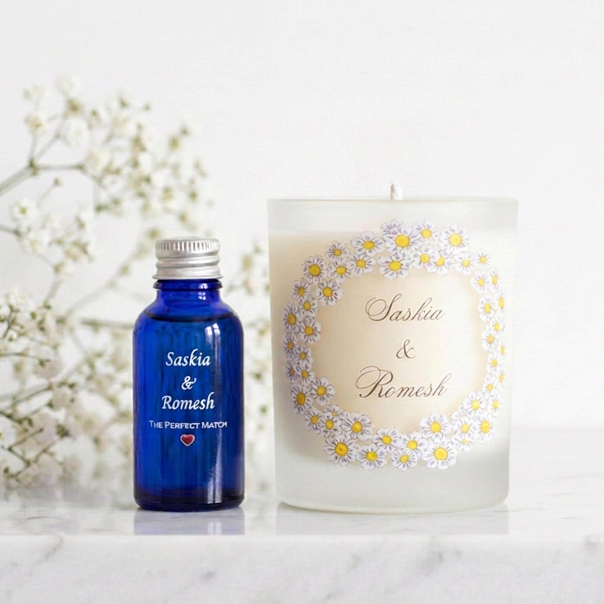 Personalised wedding candle with names and date in a hand-drawn daisy design on frosted glass