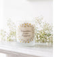 Personalised engagement candle with couple's names in a hand-drawn daisy design on frosted glass
