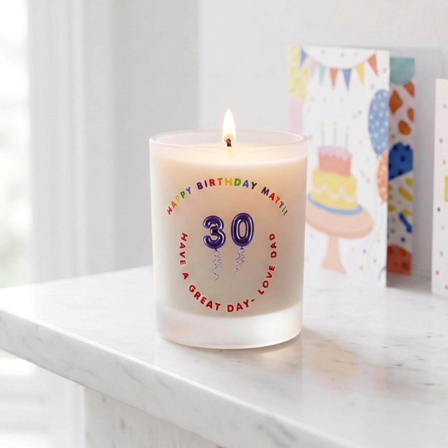 Personalised birthday candle with name and age in balloon numbers printed on frosted glass