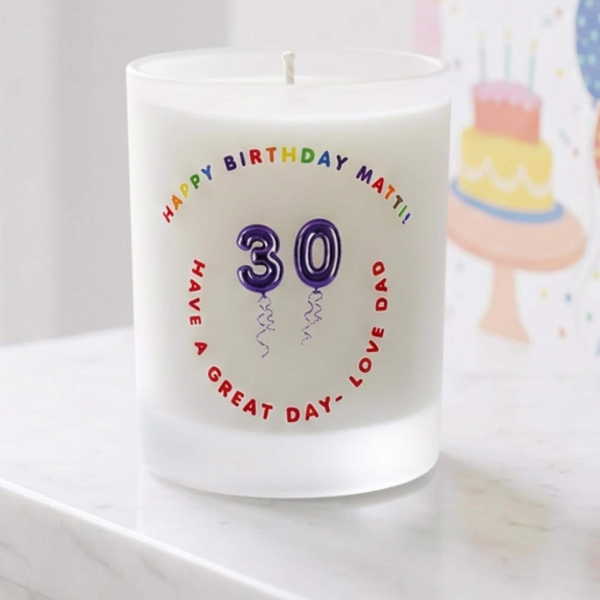 Personalised birthday candle with name and age in balloon numbers printed on frosted glass
