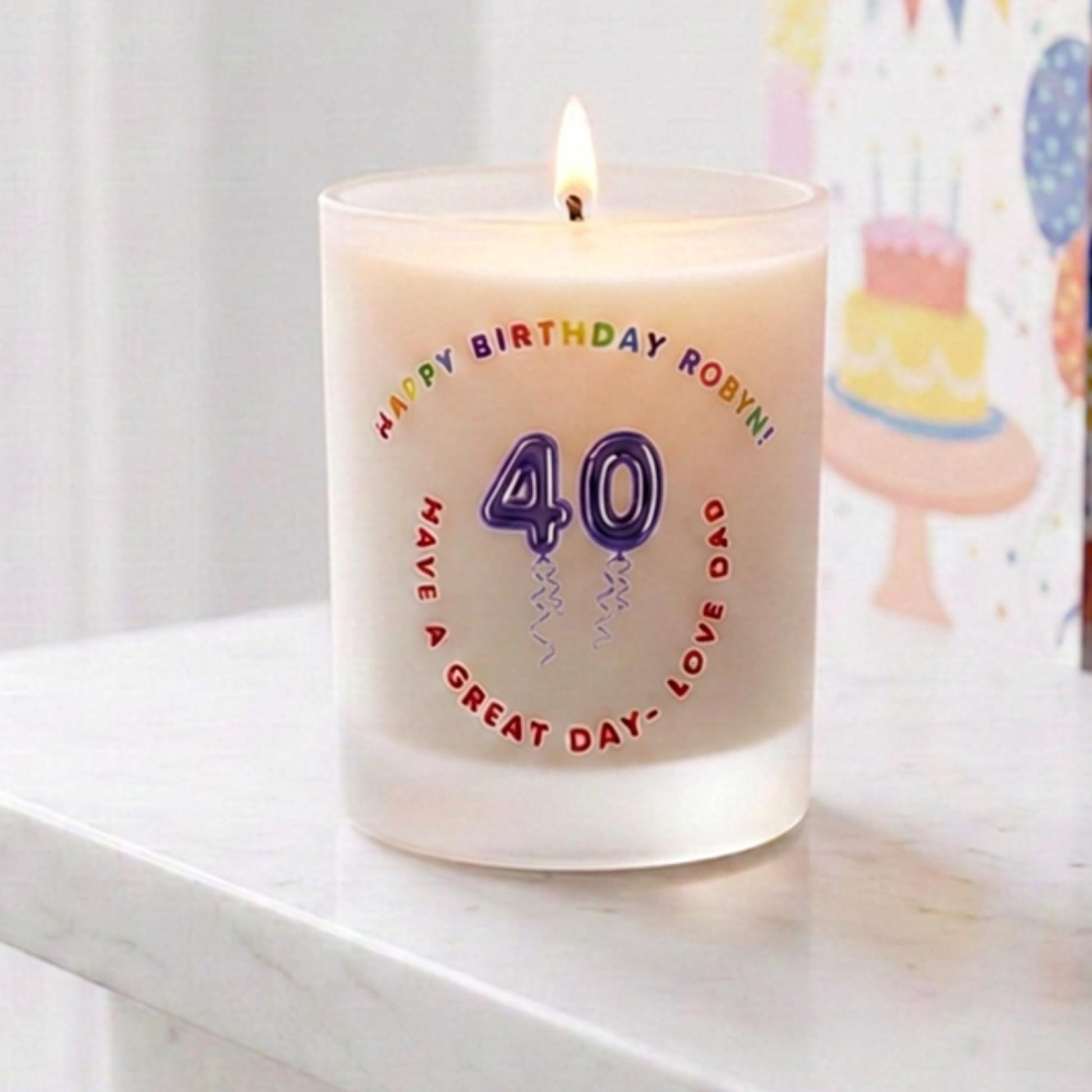 Personalised birthday candle with name and age in balloon numbers printed on frosted glass