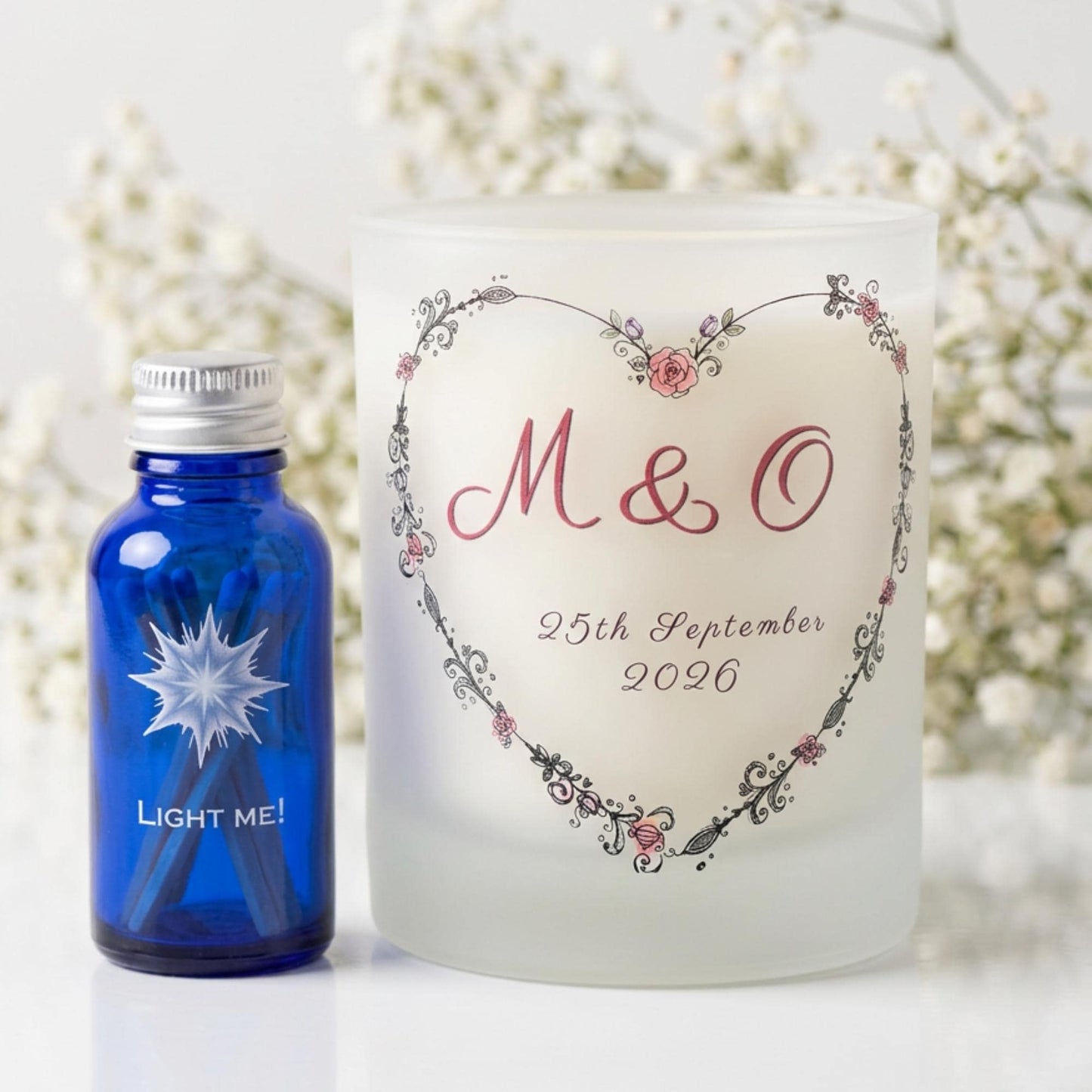 Personalised wedding candle with couple's initials and date in a boho floral heart design