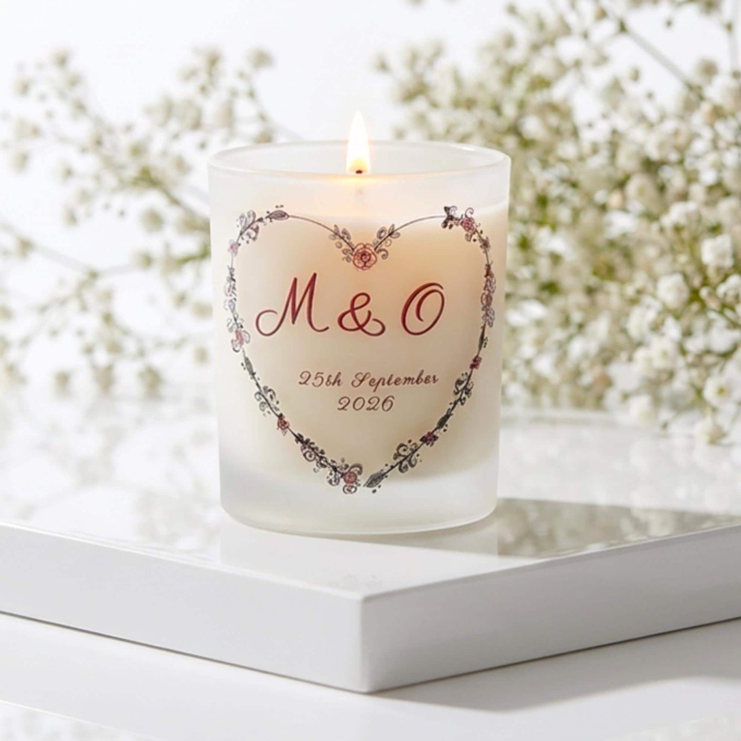Personalised wedding candle with couple's initials and date in a boho floral heart design