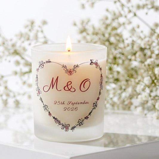 Personalised wedding candle with couple's initials and date in a boho floral heart design