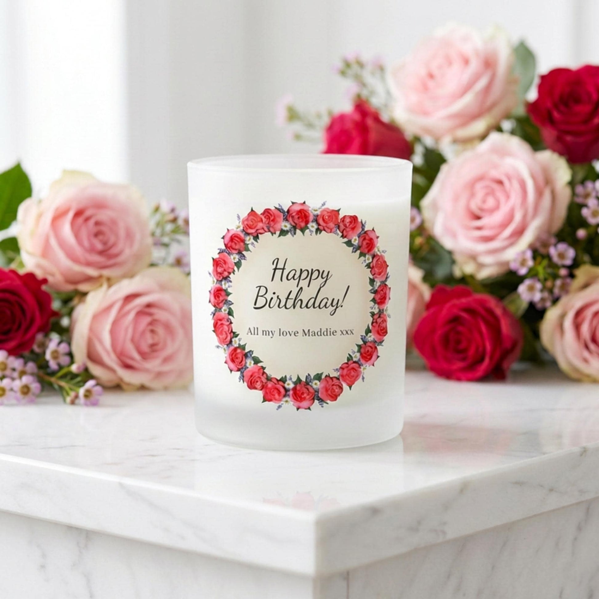 Personalised birthday candle with a rose wreath design and custom wording printed on frosted glass