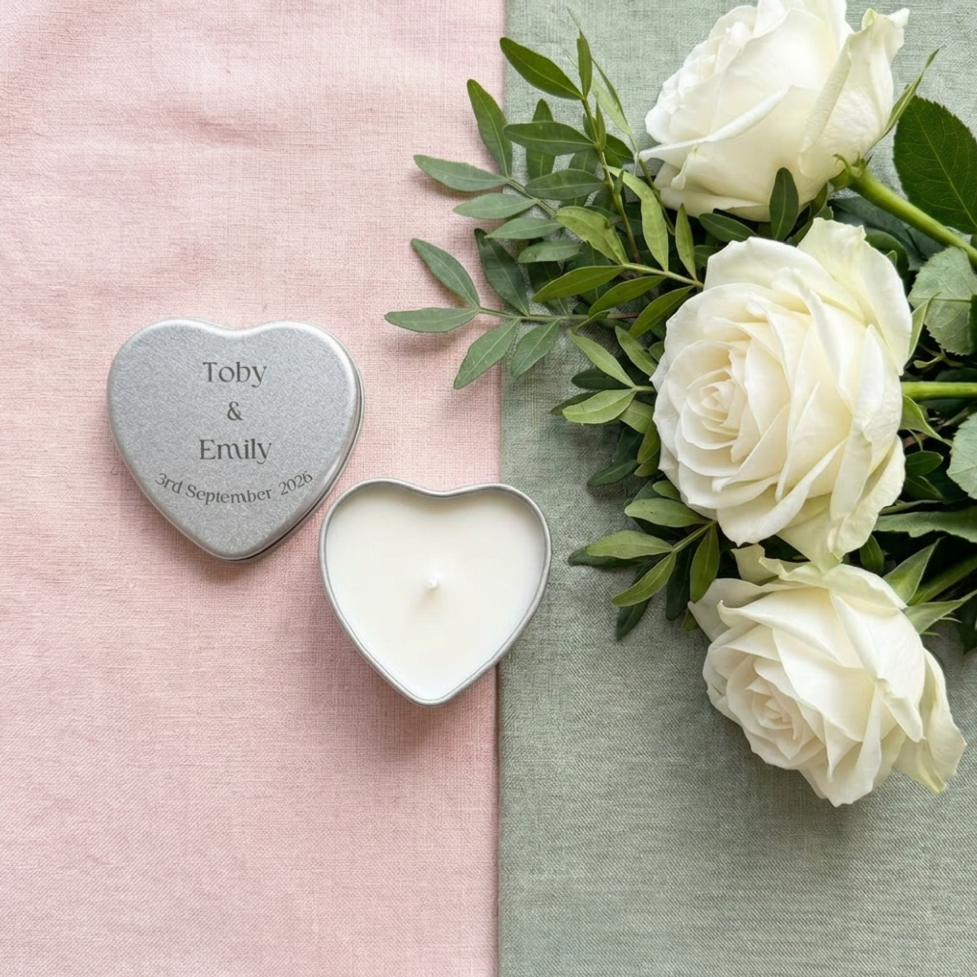 Close-up of personalised silver heart tin wedding favour candle lid printed with custom names, wedding date and colour — natural wax, cotton wick